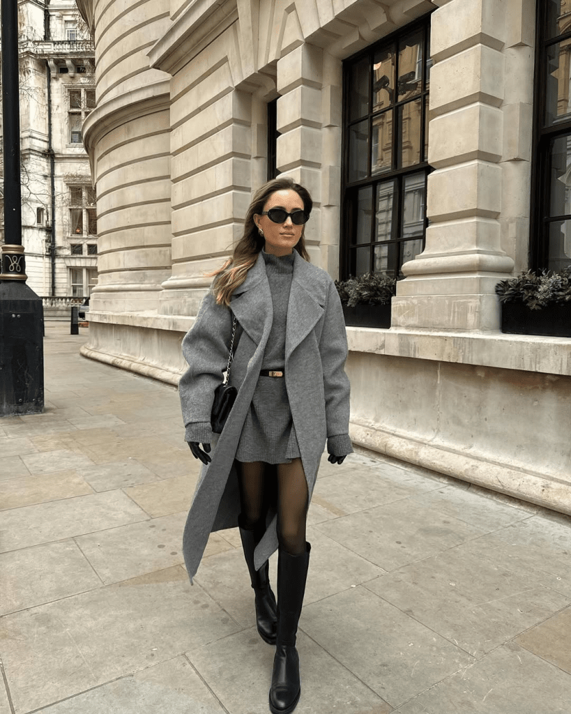 Layered Grey Outfit with Black Riding Boots and a Draped Sweater — Riding Boots Outfits
