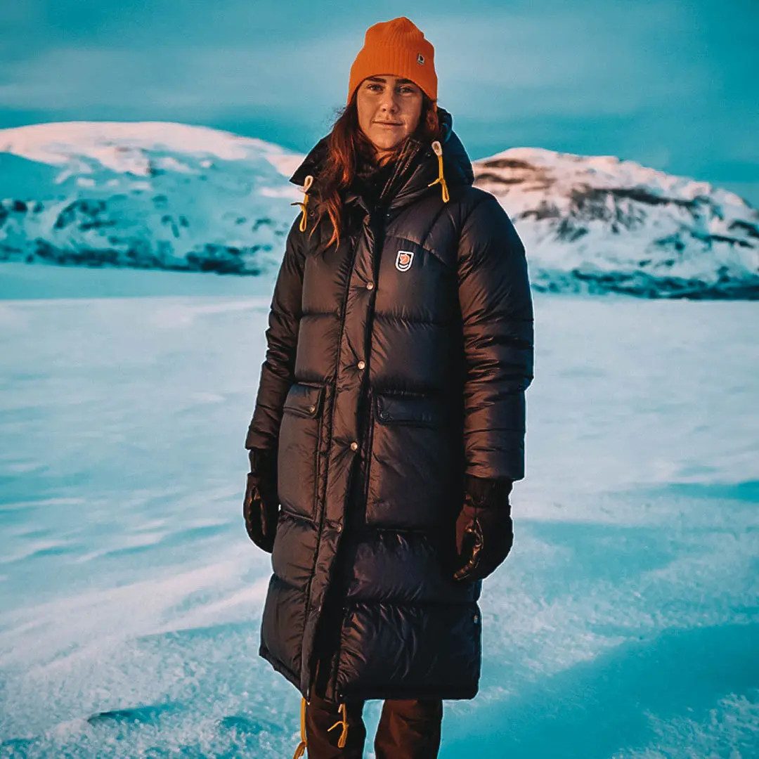 Long Black Puffer Coat and Orange Beanie for Snowy Trails — Winter Hiking Outfits