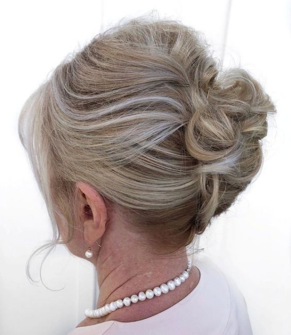 Elegant Loose Chignon With Grey Streaks Elegant Loose Chignon With Grey Streaks — Winter Hairstyles for Women Over 60