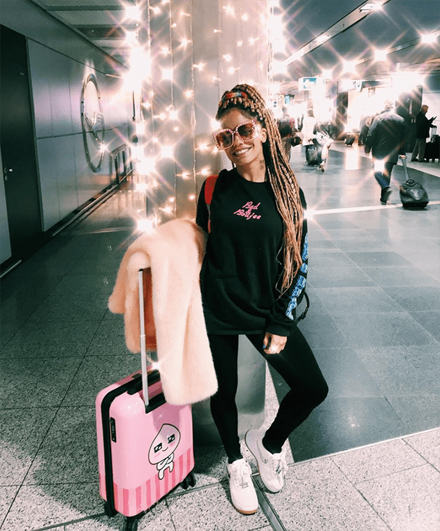 Graphic Sweatshirt and Leggings with a Vibrant Pink Faux Fur Coat — Winter Airport Outfits