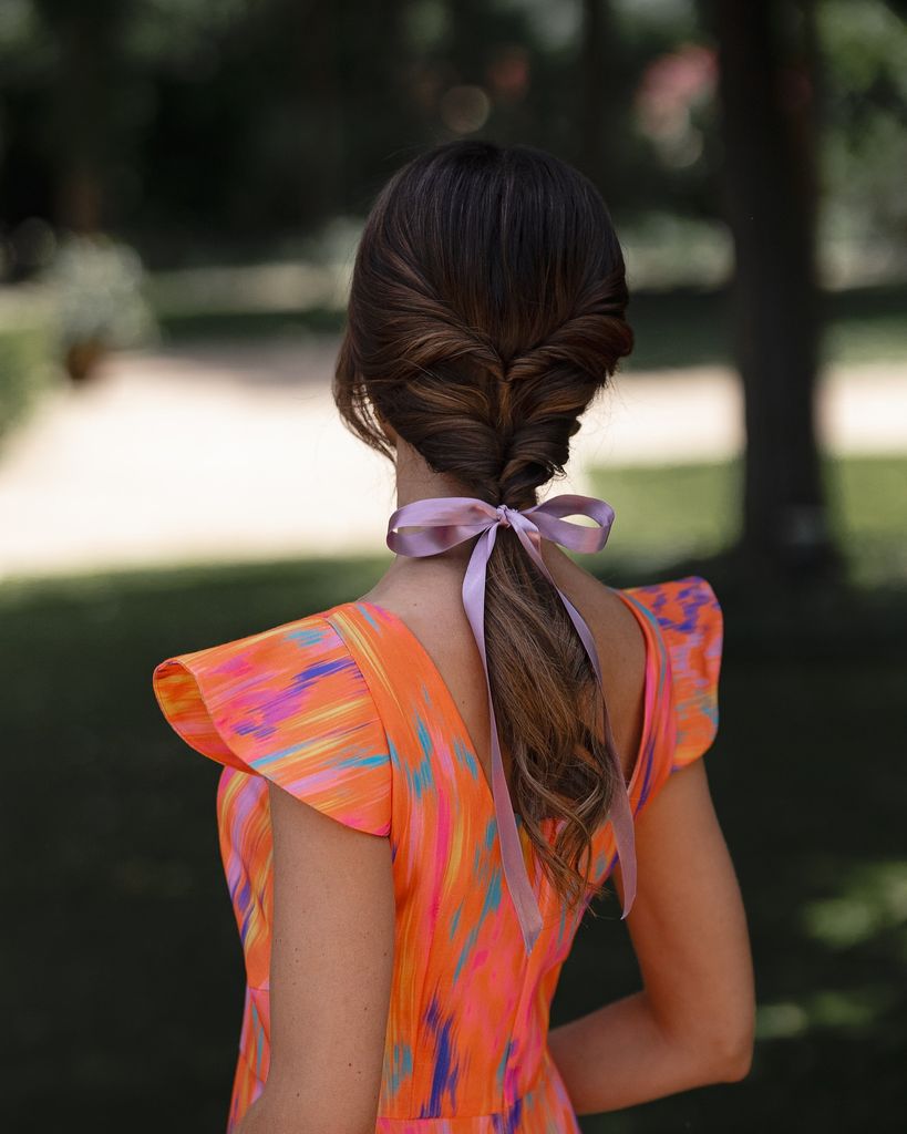 Braided Ponytail With Lilac Bow Accent — Winter Wedding Guest Hairstyles