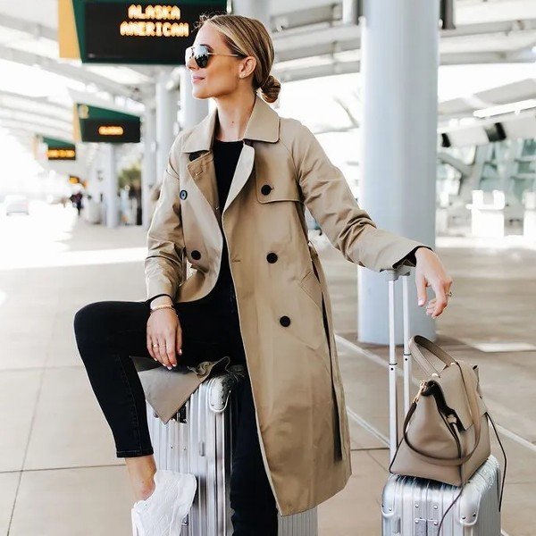 Classic Beige Trench Coat Over Black Basics for a Polished Travel Look — Winter Airport Outfits