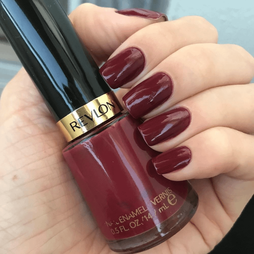 One Hand Close-Up Deep Burgundy Glossy Medium Oval Nails One Hand Close-Up Deep Burgundy Glossy Medium Oval Nails — Winter Nail Colors for Women Over 70