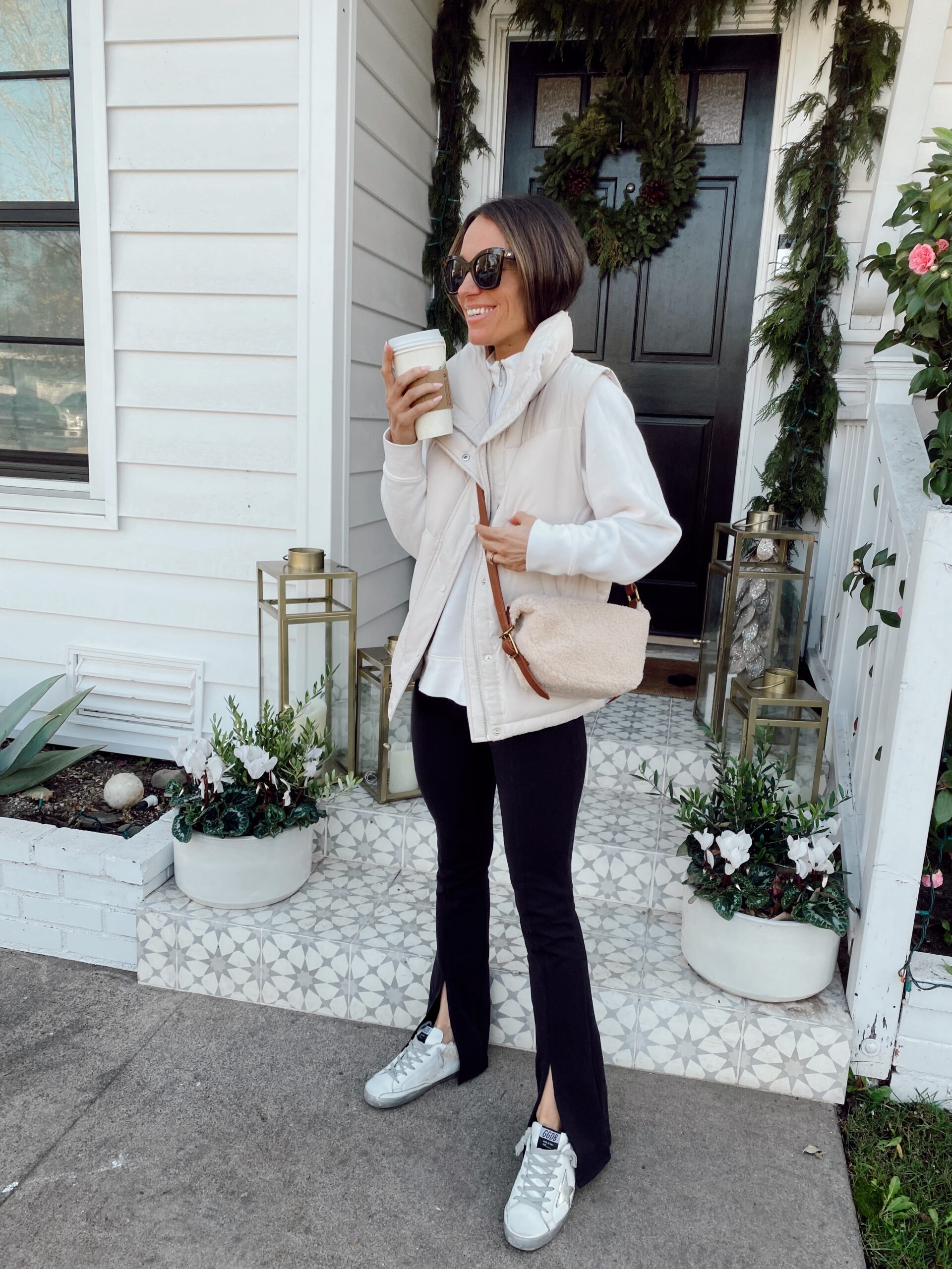 Cream Puffer Vest Over Hoodie and Split-Hem Pants — Puffer Vest Outfits