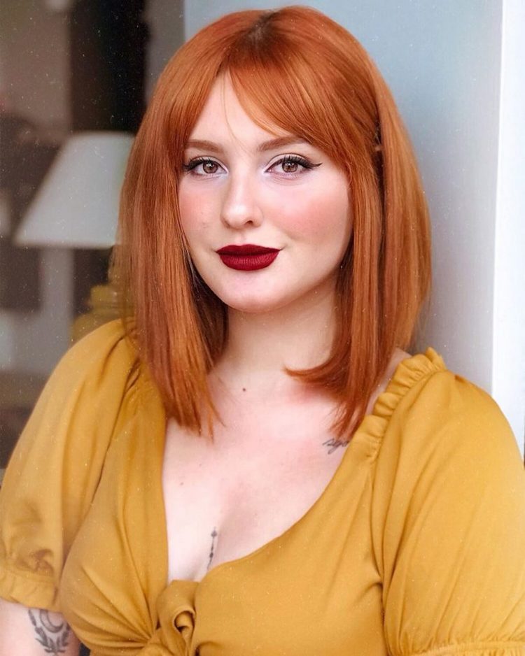 Vibrant Red Bob With Face-Framing Bangs — Winter Haircuts for Round Faces
