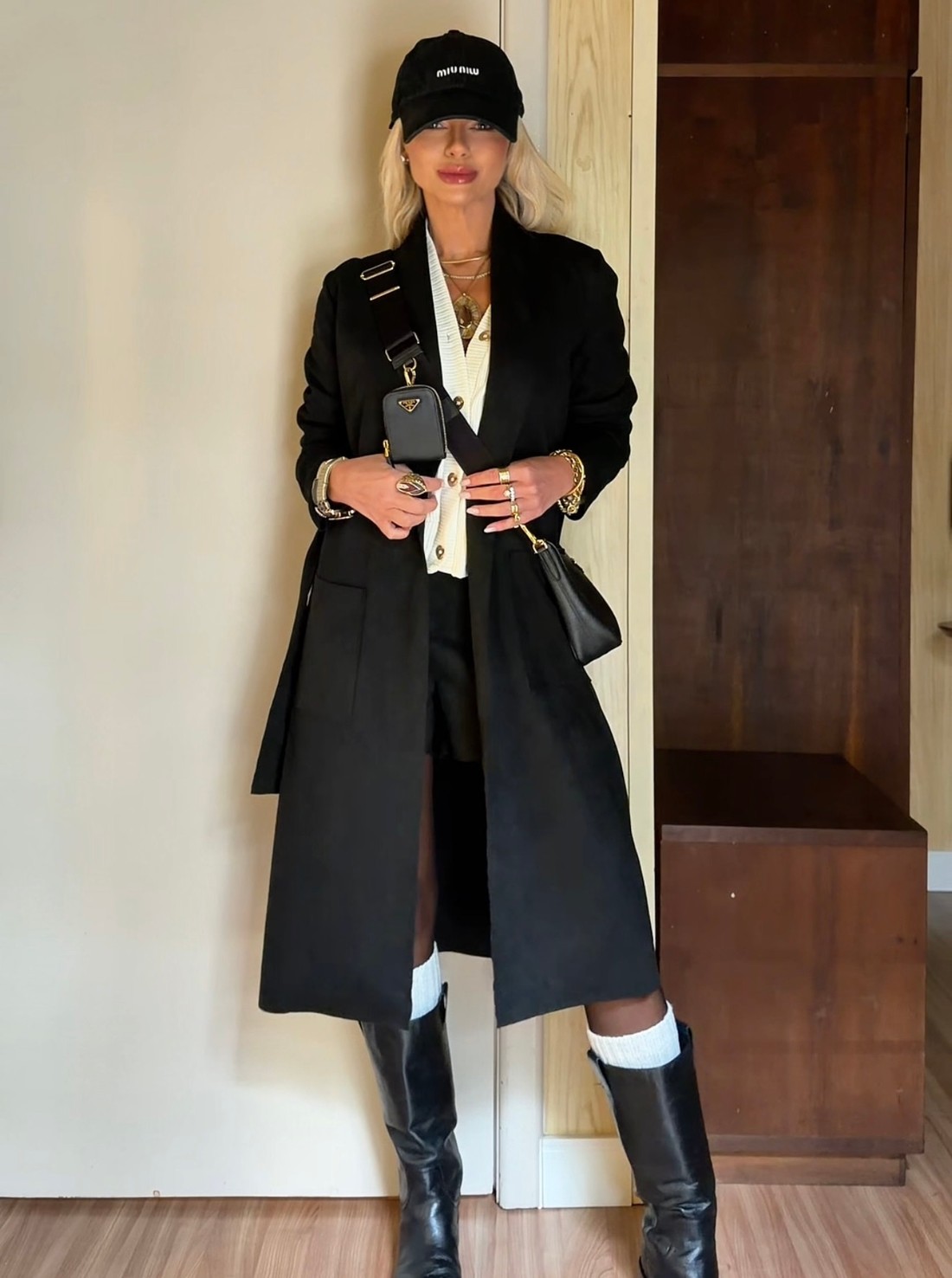Long Black Coat with Shorts and Knee-High Boots — Long Coat Outfits