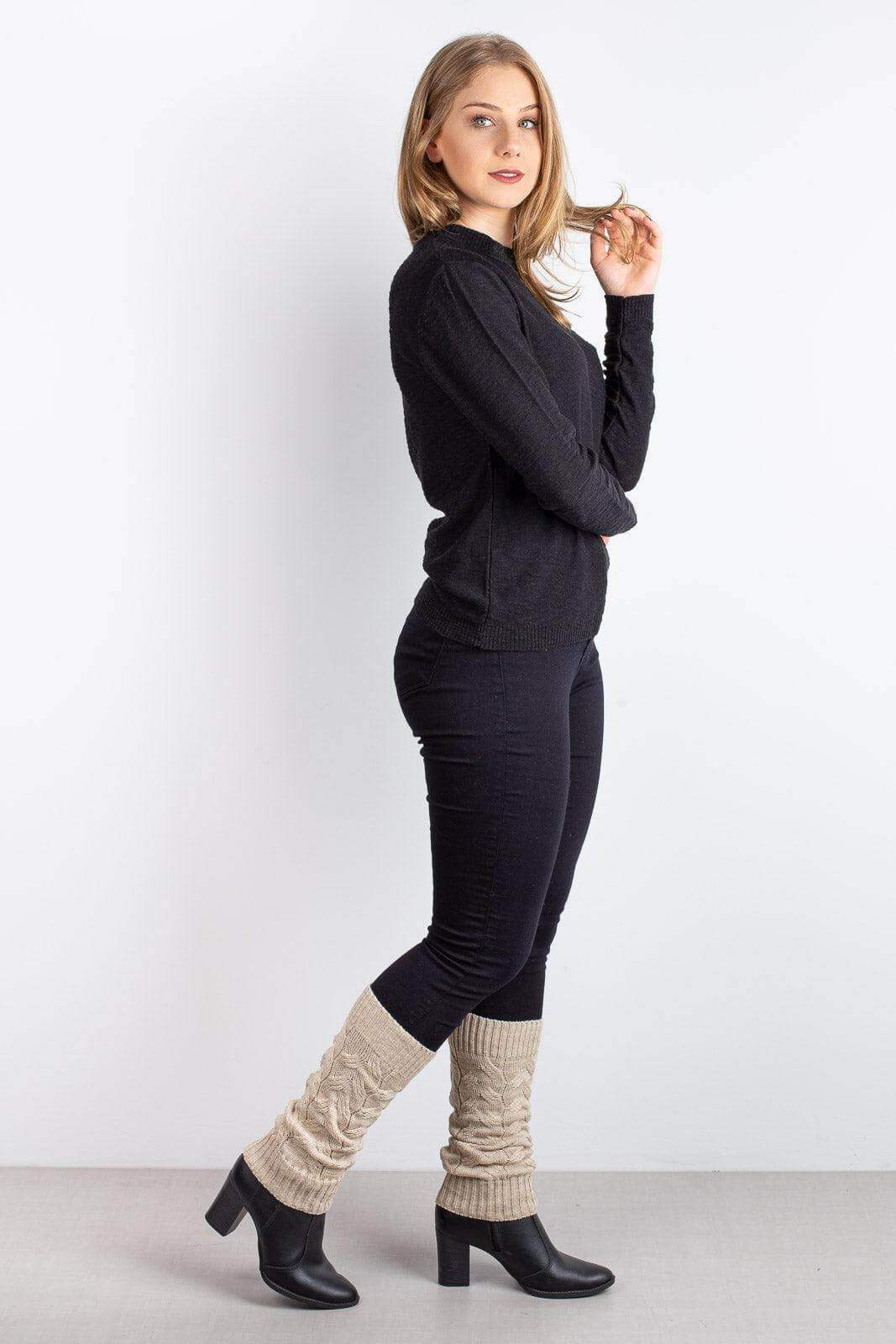 Sleek Black Outfit with Beige Knit Leg Warmers and Heeled Boots — Leg Warmers Outfits