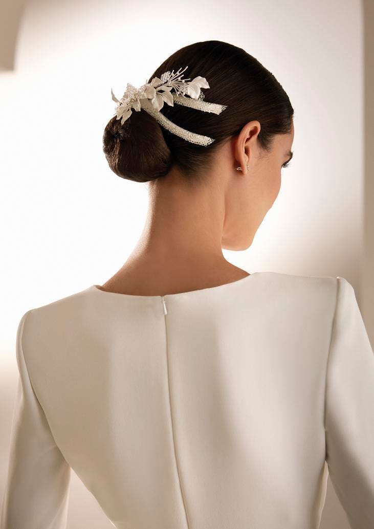 Glamorous Low Bun with Ornate Accessory — Winter Bun Hairstyles