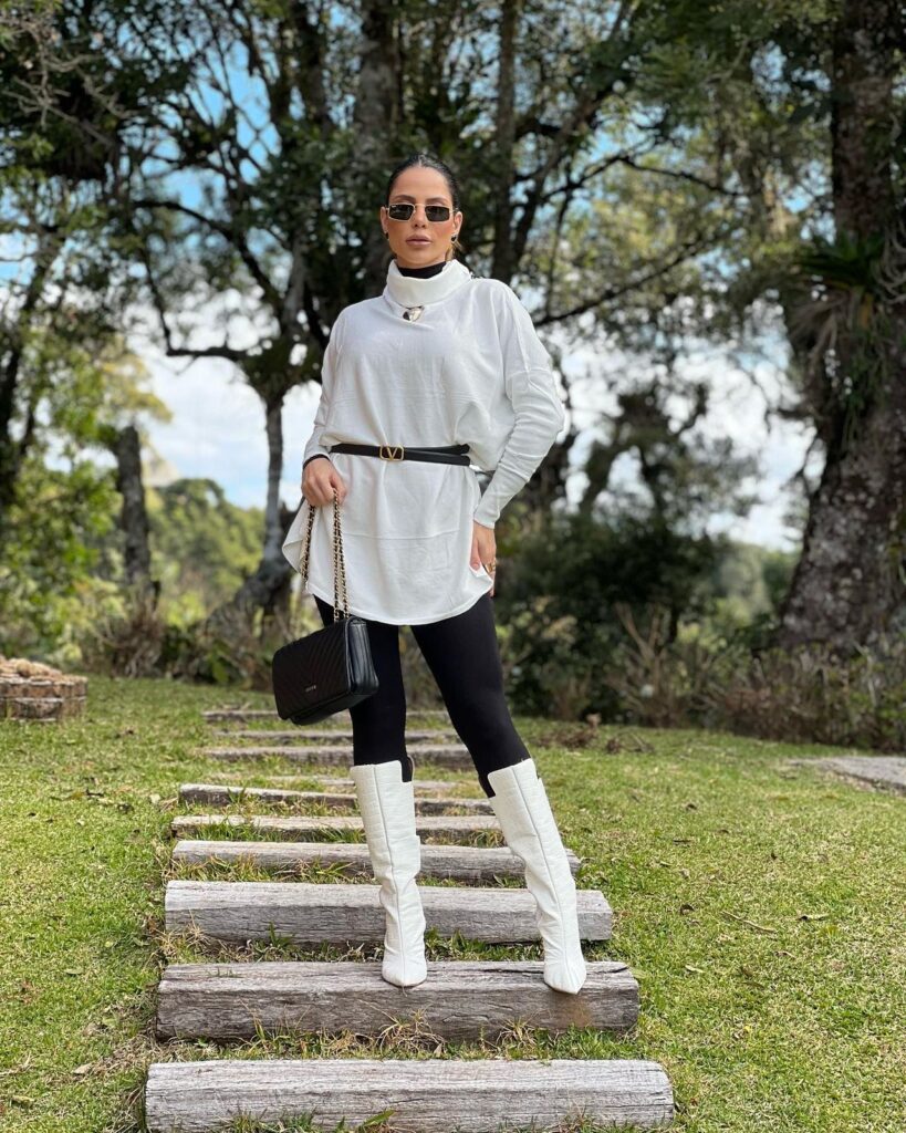 White Knit Top with Black Leggings and White Knee-High Boots — Winter Outfits for Warm Weather