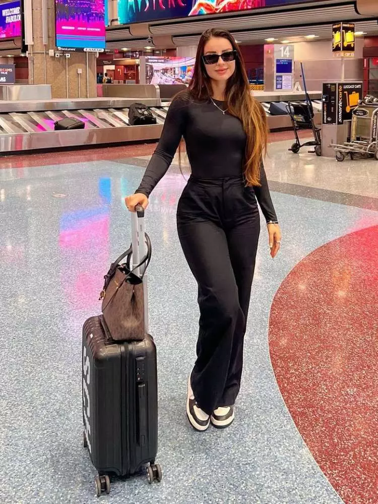 Sleek All-Black Outfit with Form-Fitting Top and Wide-Leg Pants — Winter Airport Outfits