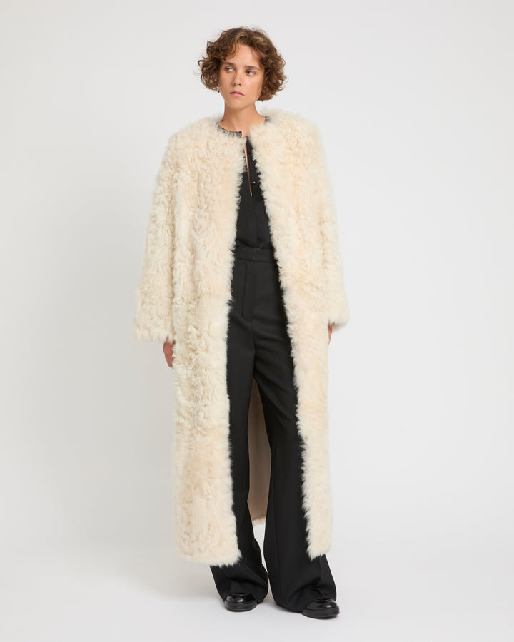 Elegant Cream Shearling Coat Over a Black Jumpsuit — Shearling Coat Outfits