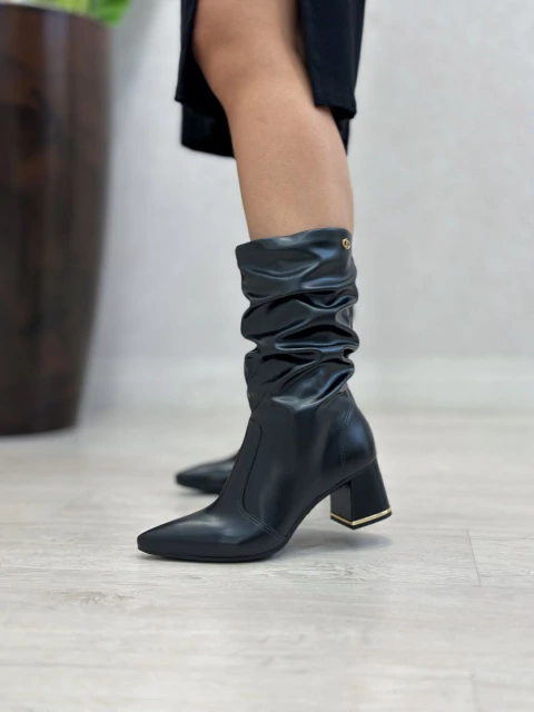 Close-up on Black Leather Slouchy Boots with Gold Heel Accent — Slouchy Boots Outfits