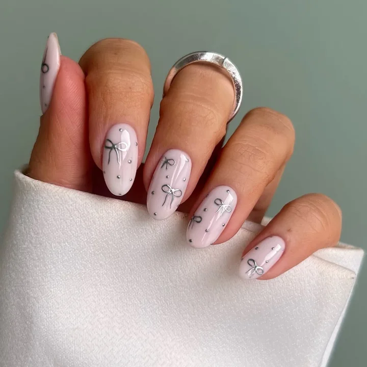 Pale Pink Oval with Silver Bows Pale Pink Oval with Silver Bows — Cute Winter Nails