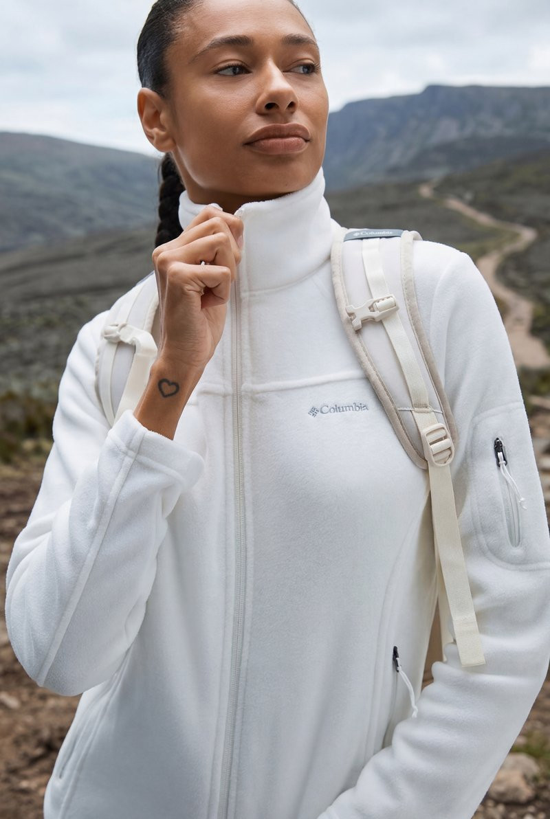 White Fleece Jacket with Beige Backpack Straps on Trail — Winter Hiking Outfits