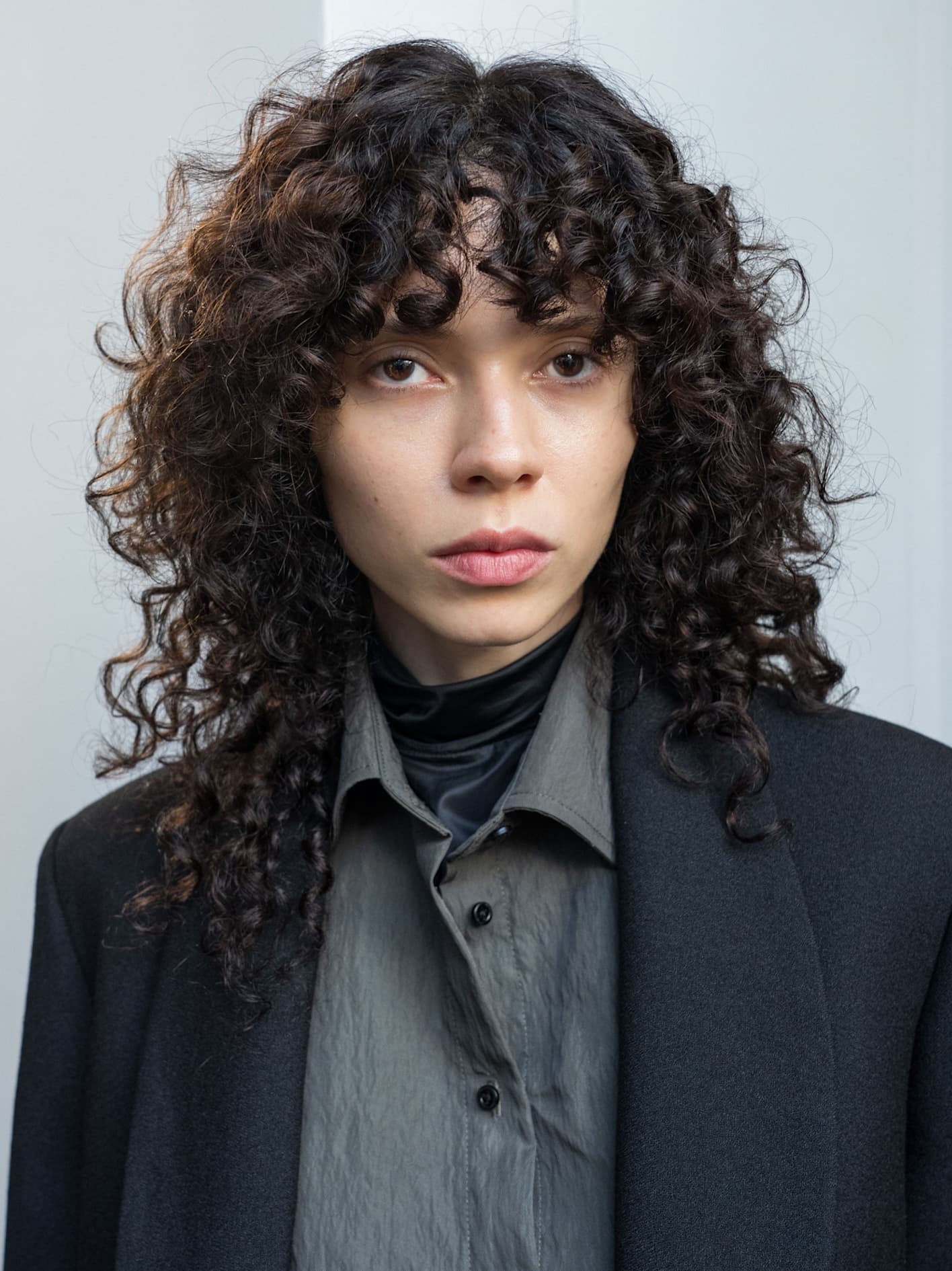 Curly Shag With Collarbone Curtain Bangs Curly Shag With Collarbone Curtain Bangs — Winter Haircuts for Heart Shaped Faces