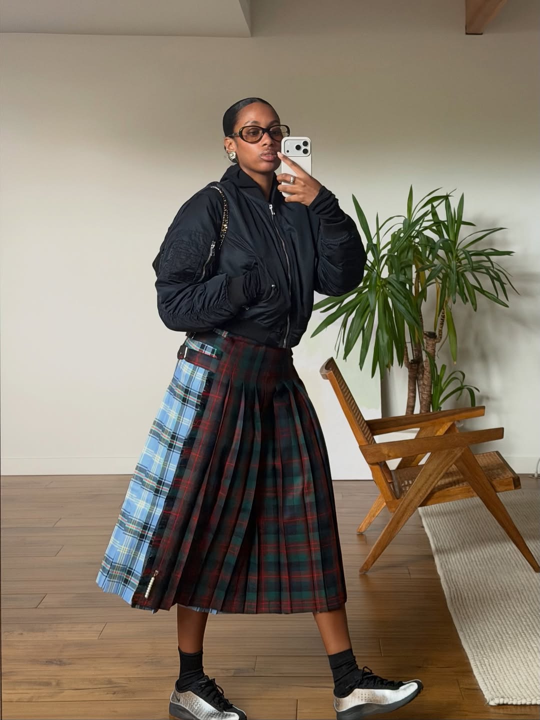 Black Bomber Jacket with Asymmetrical Plaid Skirt and Silver Sneakers Black Bomber Jacket with Asymmetrical Plaid Skirt and Silver Sneakers — Winter Outfits