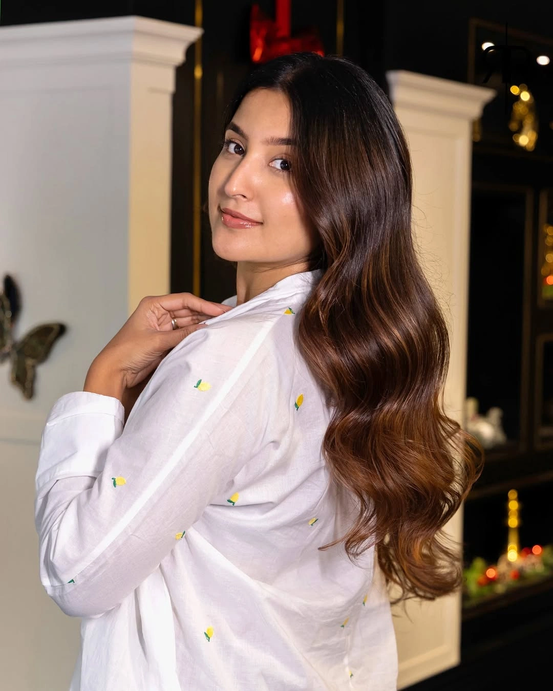 Very long dark-brown hair with smooth upper lengths and broad waves