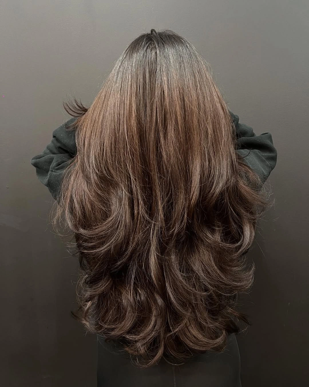 Long brown hair with smooth crown and layered curved ends