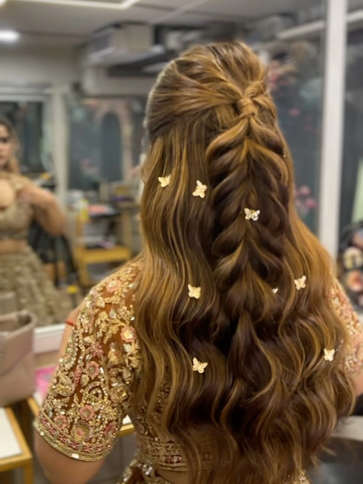 Long half-up waves with central braid and butterfly-shaped decorations