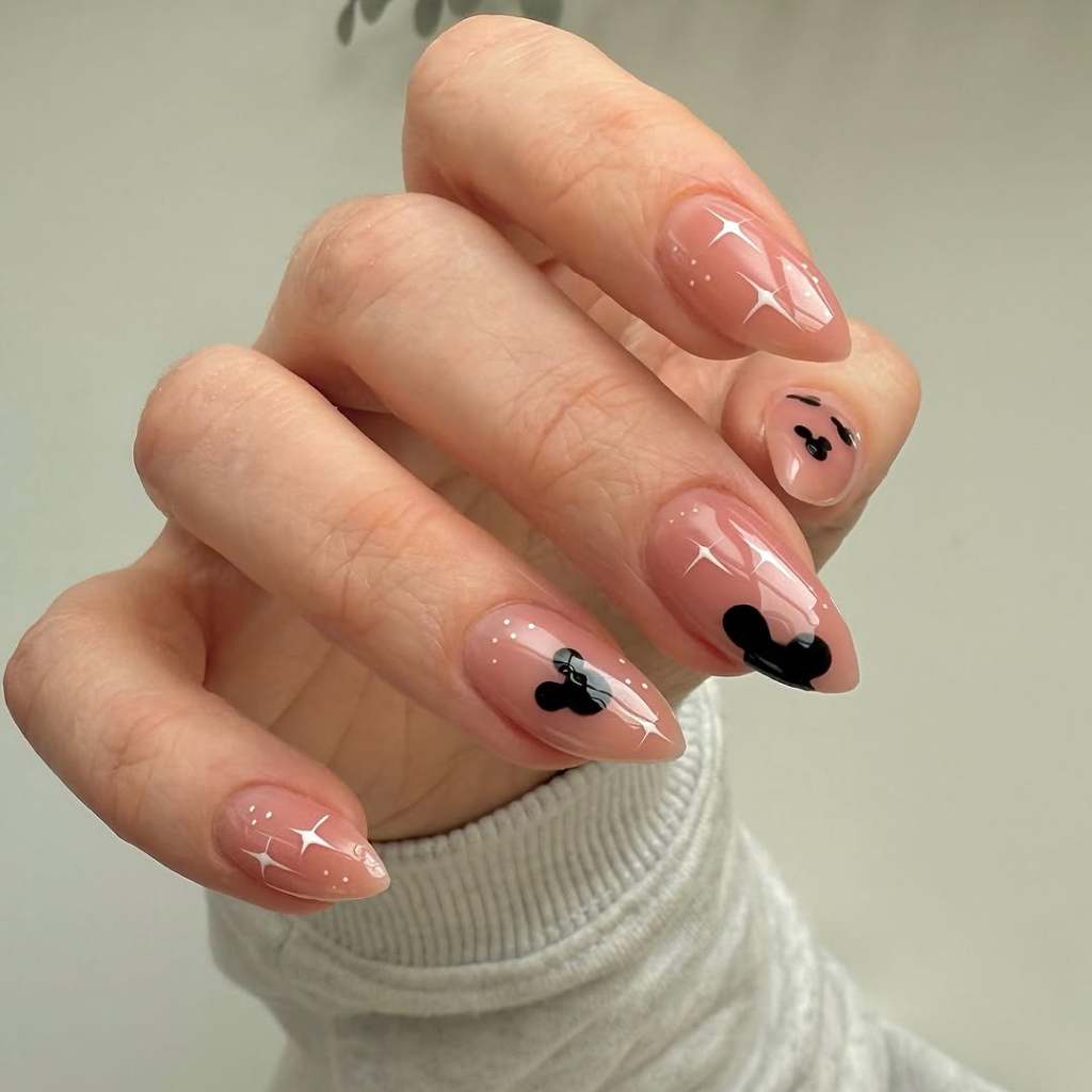 Minimalist Mickey Silhouette Sheer Nude Almond Nails Minimalist Mickey Silhouette Sheer Nude Almond Nails — Aesthetic Disney Nails