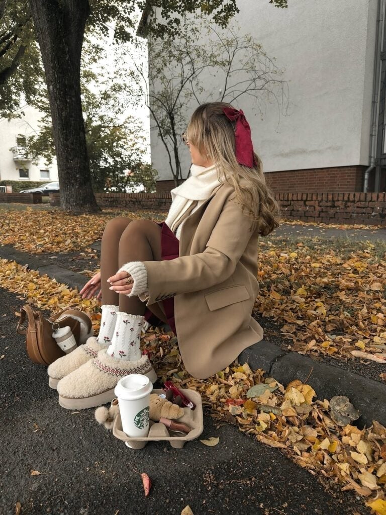 Ugg Slippers with Pom-Poms Paired with a Burgundy Skirt and Beige — Aesthetic Ugg Tasman Outfit