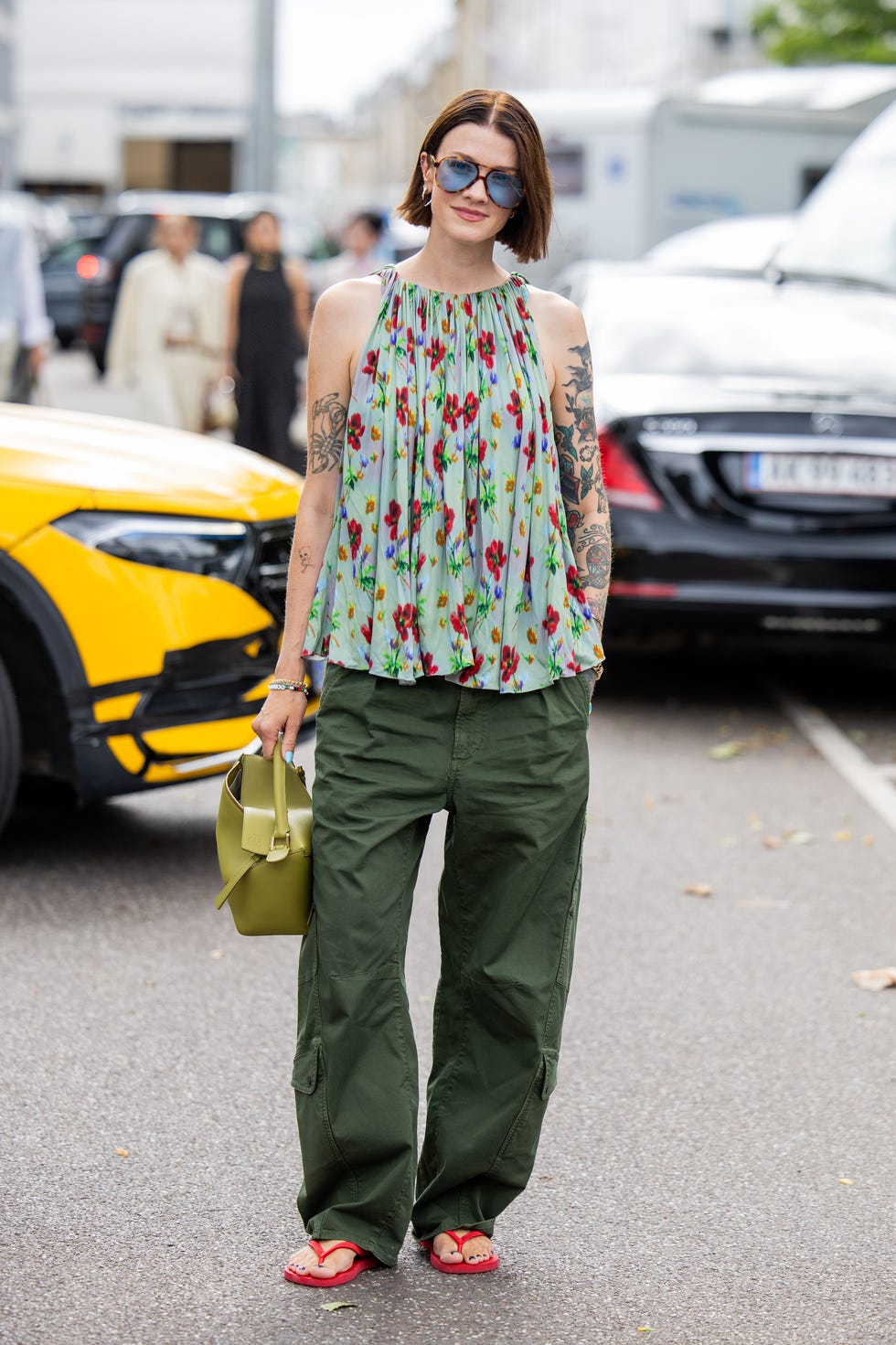 Olive Green Cargo Pants with a Floral Halter Top and Red Flip-Flops — Chic Green Cargo Pants Outfit