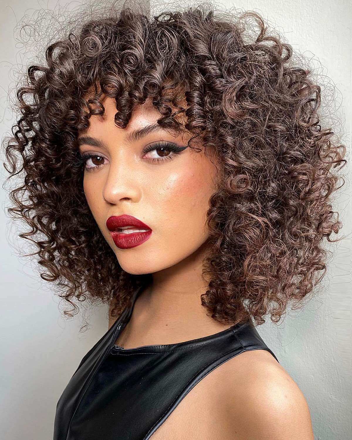 Dark Brown Bob With Subtle Highlights And Curly Bangs — Classy 3c Hairstyles