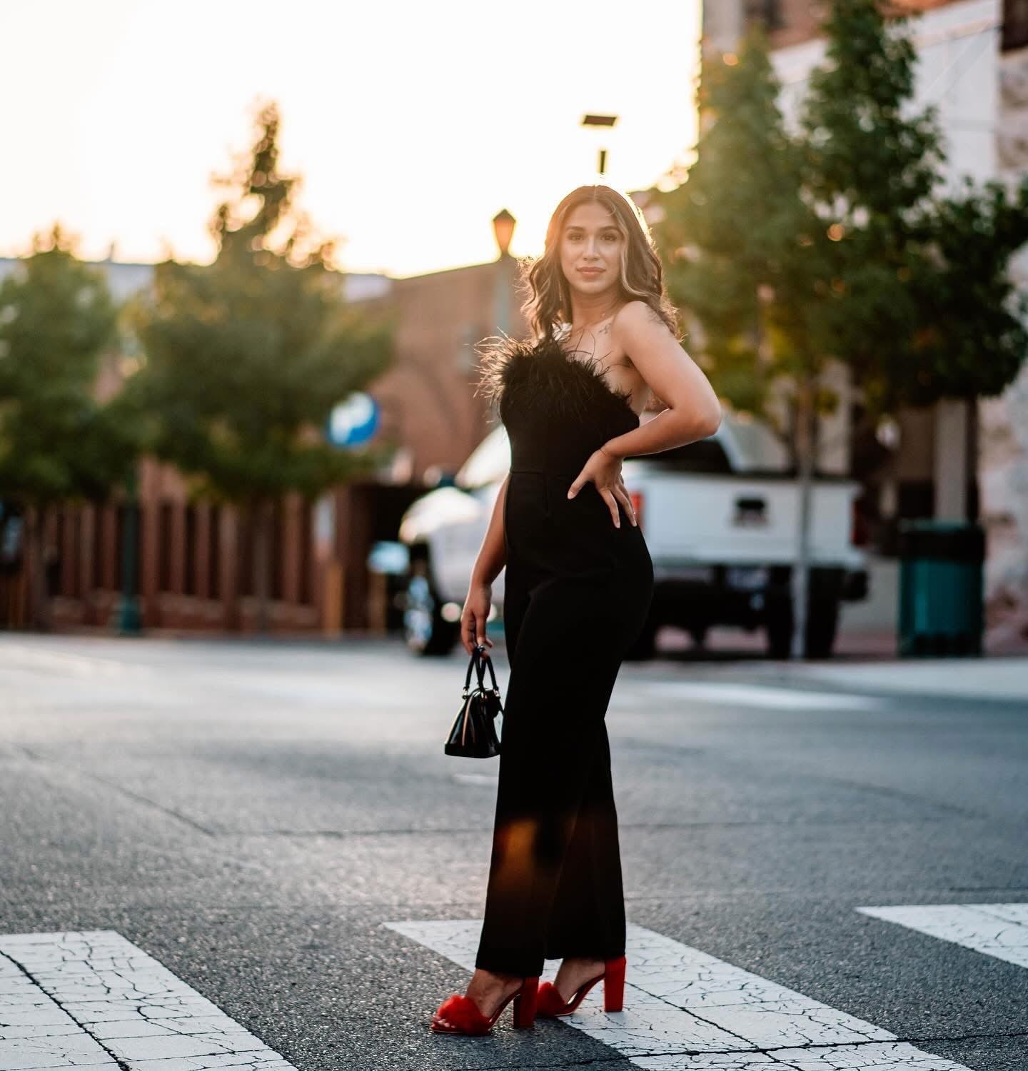 Strapless Jumpsuit With Feather Trim and Red Heels — Classy Black Jumpsuit Outfit