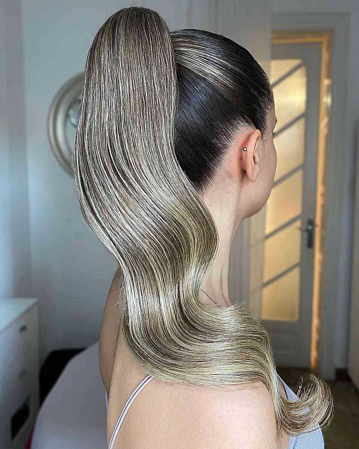 Ash Blonde Ponytail With Sculpted Waves And Darker Roots Ash Blonde Ponytail With Sculpted Waves And Darker Roots — Classy Blonde Ponytail
