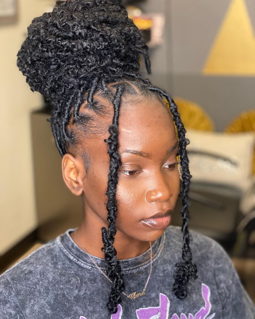 High Bun With Loose Curly Strands High Bun With Loose Curly Strands — Classy Butterfly Locs