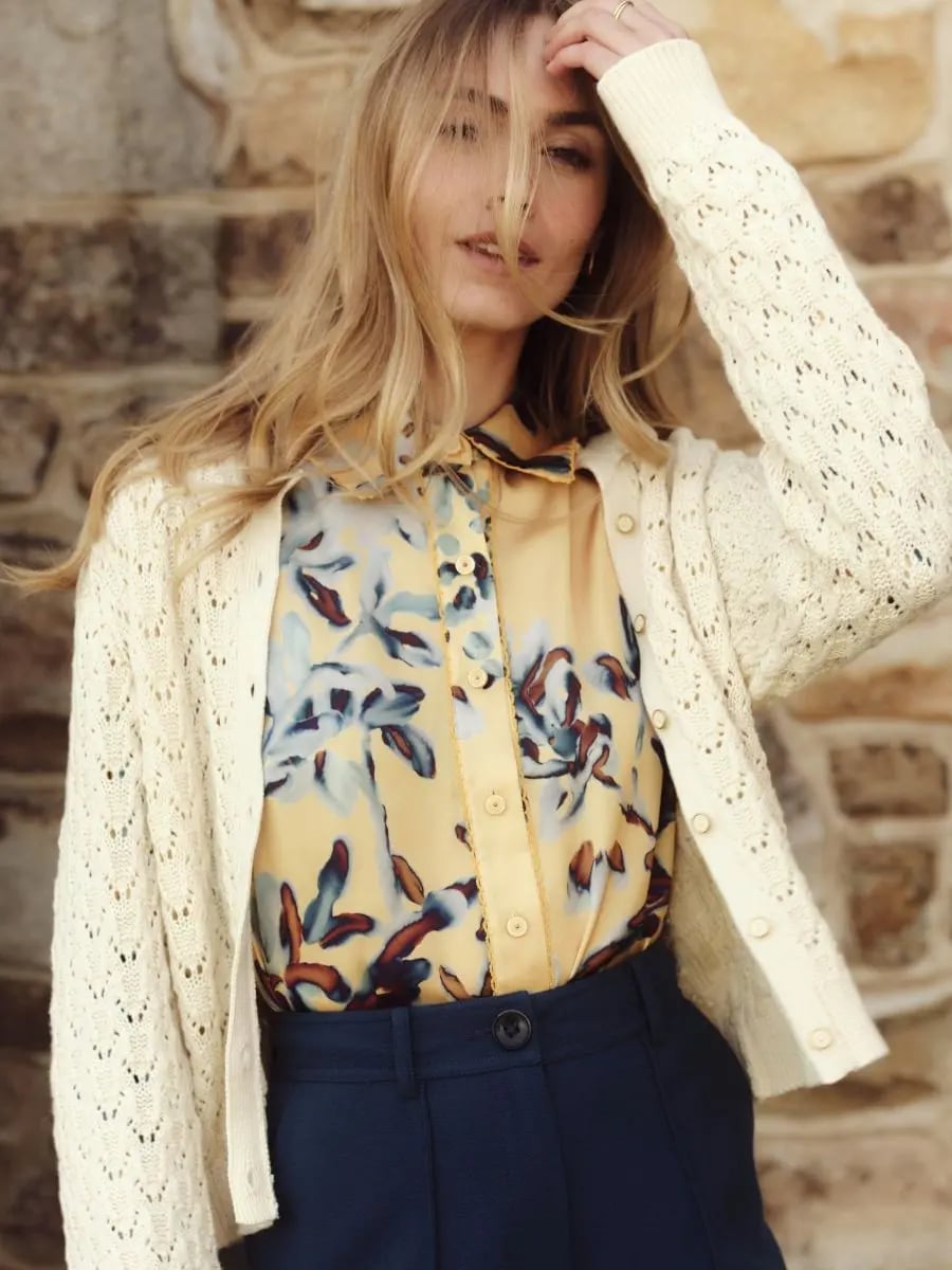 Cream Knit Cardigan Over Floral Blouse and Navy Trousers Cream Knit Cardigan Over Floral Blouse and Navy Trousers — Classy Capsule Wardrobe
