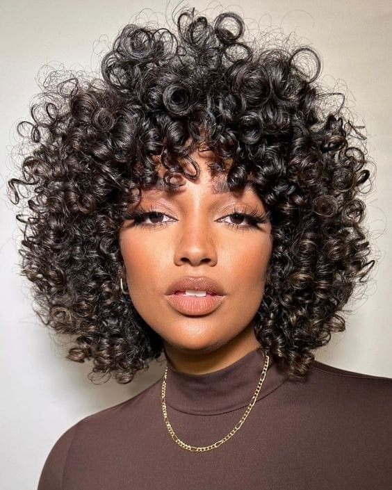 Short Black Curly Pixie Cut With Textured Bangs And A Side Parting — Classy Curly Hair Cutting