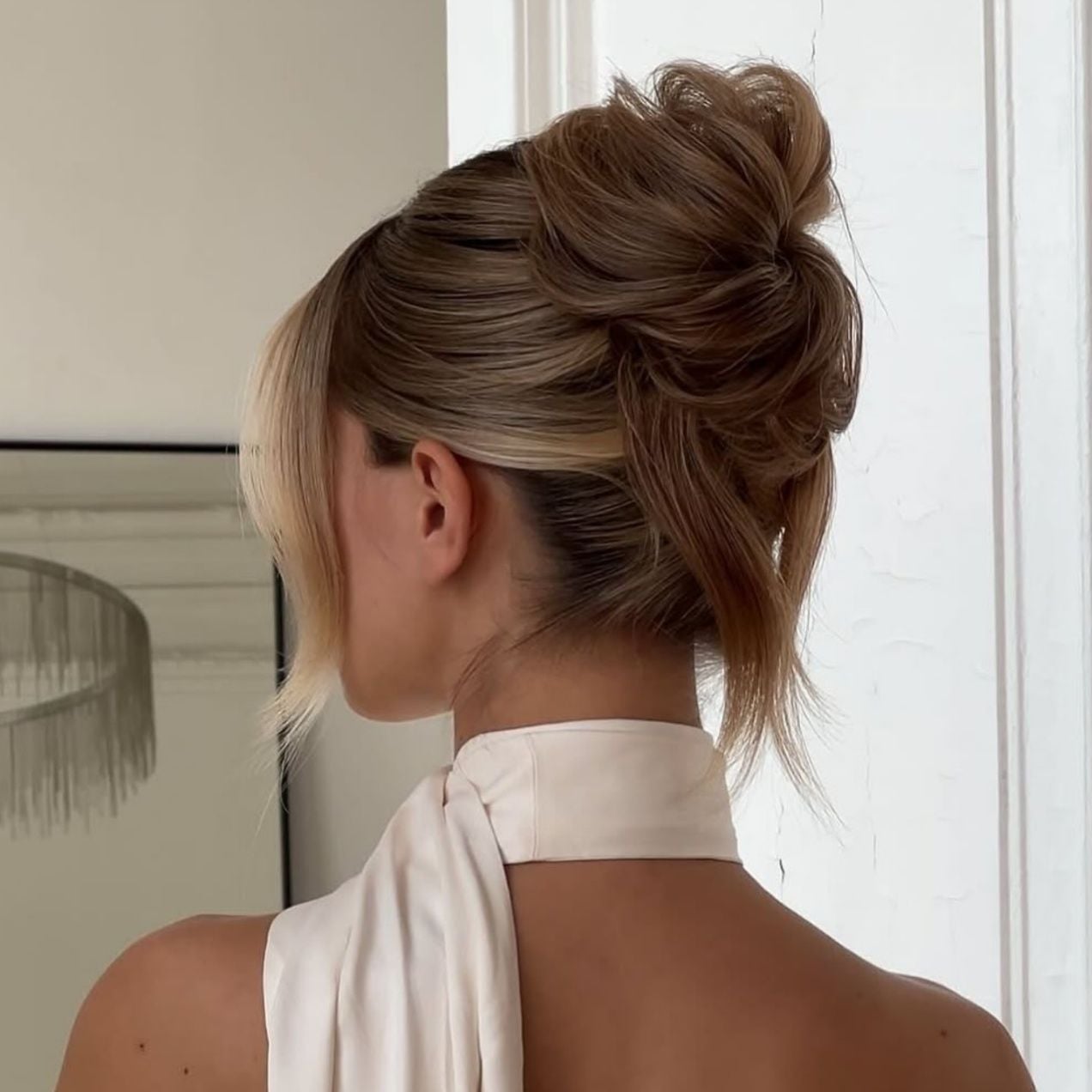 Polished Ash Blonde Low Bun With Wispy Bangs — Classy Dance Hairstyles