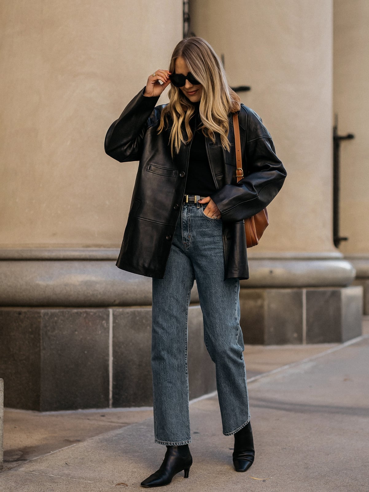 Oversized Black Leather Jacket Over T-Shirt and Blue Jeans Oversized Black Leather Jacket Over T-Shirt and Blue Jeans — Classy Leather Outfits