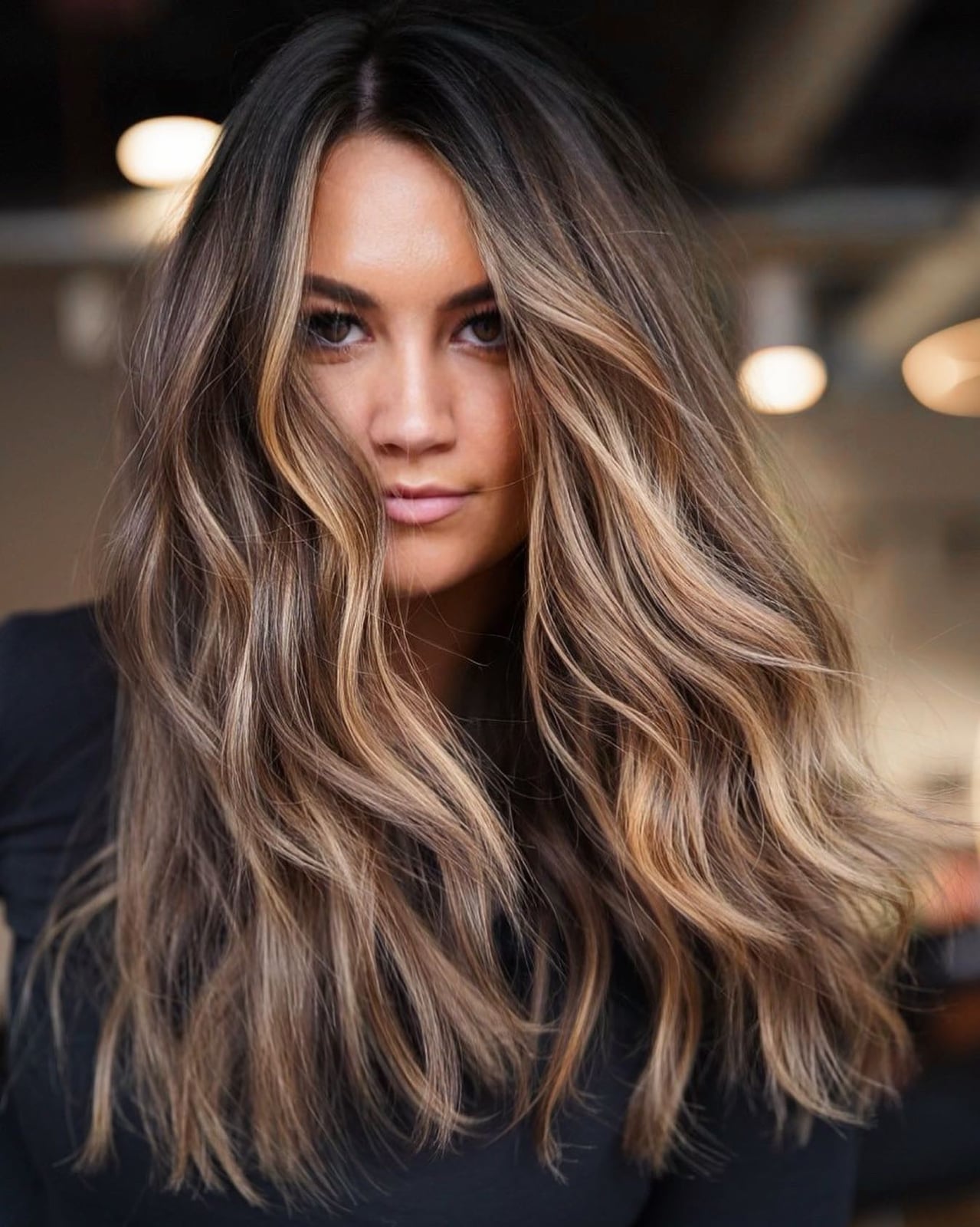 Mid-Back Wavy Hair With Curtain Bangs — Classy Light Brown Balayage
