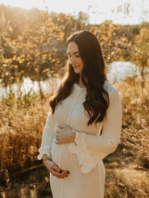 Cream Ribbed Knit Dress With Ruffled Cuffs and Natural Setting — Classy Maternity Photoshoot Outfits
