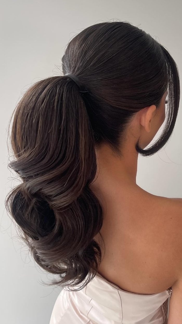 Sleek Low Ponytail With Polished Waves Sleek Low Ponytail With Polished Waves — Classy Middle Part Ponytail