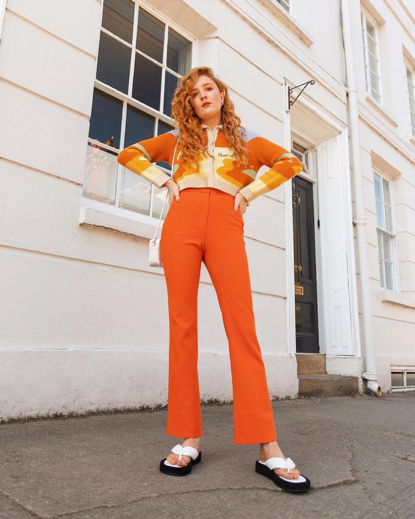 High-waisted Flared Orange Trousers with a Cropped, Close-Up Take — Classy Orange Pants Outfits