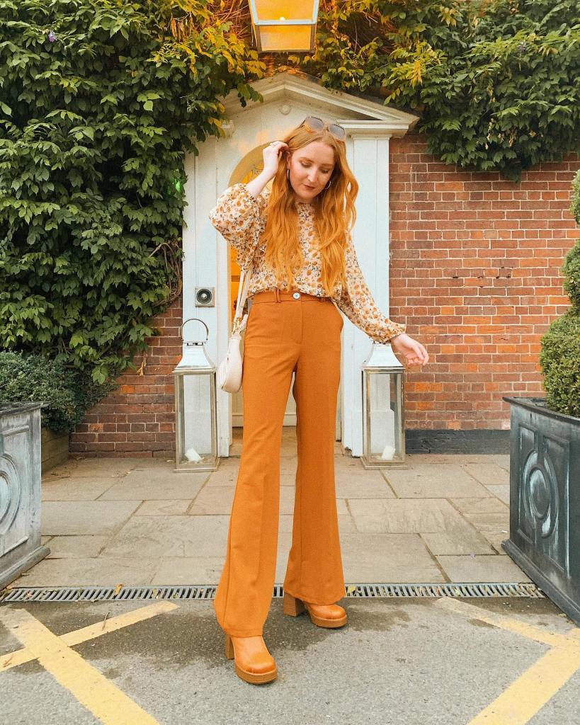 Burnt Orange Flared Trousers with a Floral Print Blouse — Classy Orange Pants Outfits