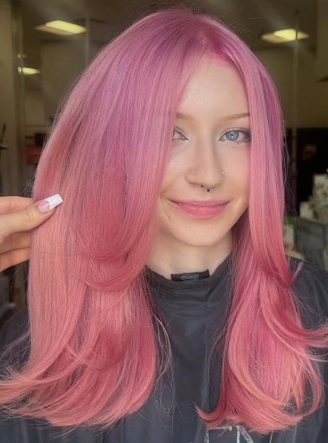 Soft Coral Pink Mid-Back Blowout With Curtain Bangs — Classy Pink Hair Color