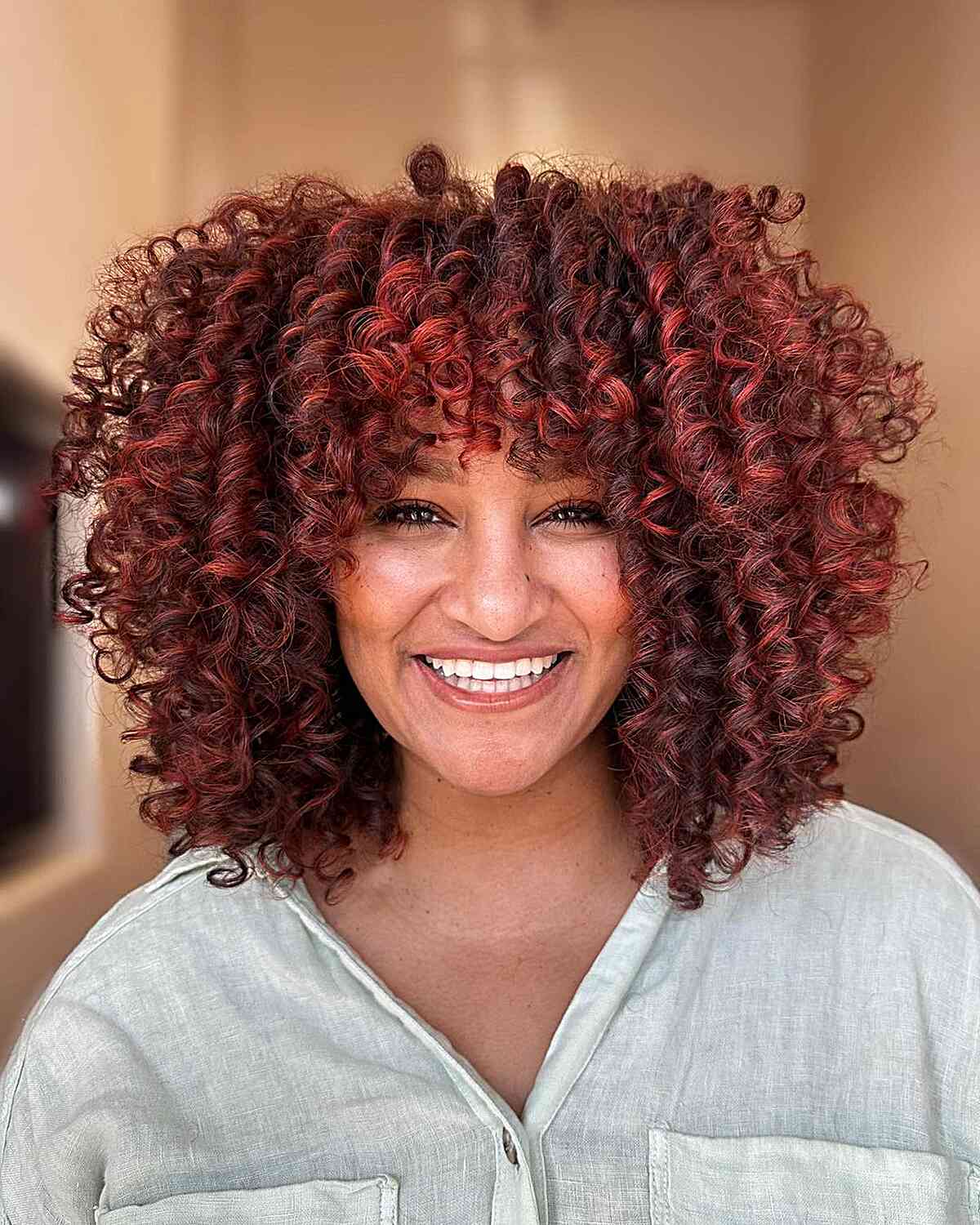 Collarbone Curls With Deep Red Balayage And Full Bangs Collarbone Curls With Deep Red Balayage And Full Bangs — Classy Red Balayage