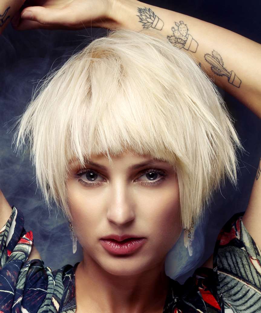 Platinum Blonde Shag Bob Chin Length With Blunt Bangs, Close-Up Take Platinum Blonde Shag Bob Chin Length With Blunt Bangs, Close-Up Take — Classy Short Shaggy Haircut