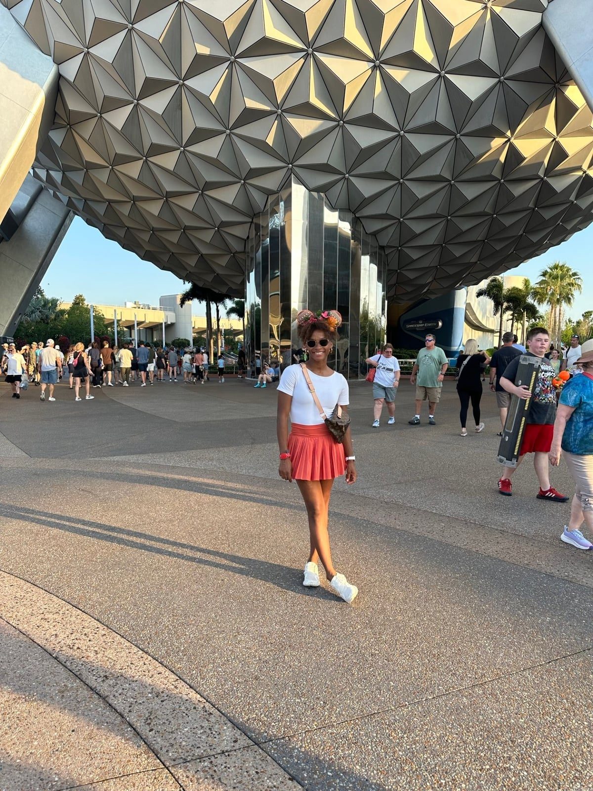 Orange Pleated Mini Skirt and Mickey Mouse Ears Orange Pleated Mini Skirt and Mickey Mouse Ears — Classy Theme Park Outfits