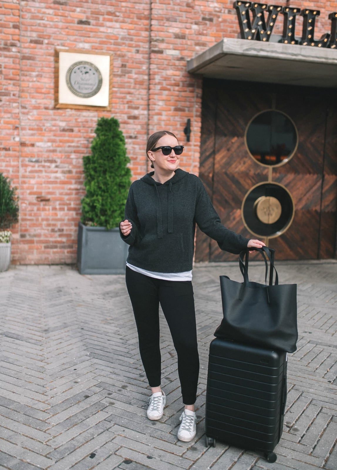 Grey Hoodie Over T-Shirt and Black Leggings Grey Hoodie Over T-Shirt and Black Leggings — Classy Travel Outfits