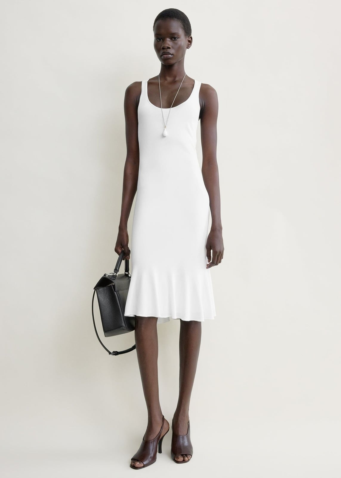 White Ribbed Knit Midi Dress With Ruffled Hem, Close-Up Take White Ribbed Knit Midi Dress With Ruffled Hem, Close-Up Take — Classy White Dresses Outfit