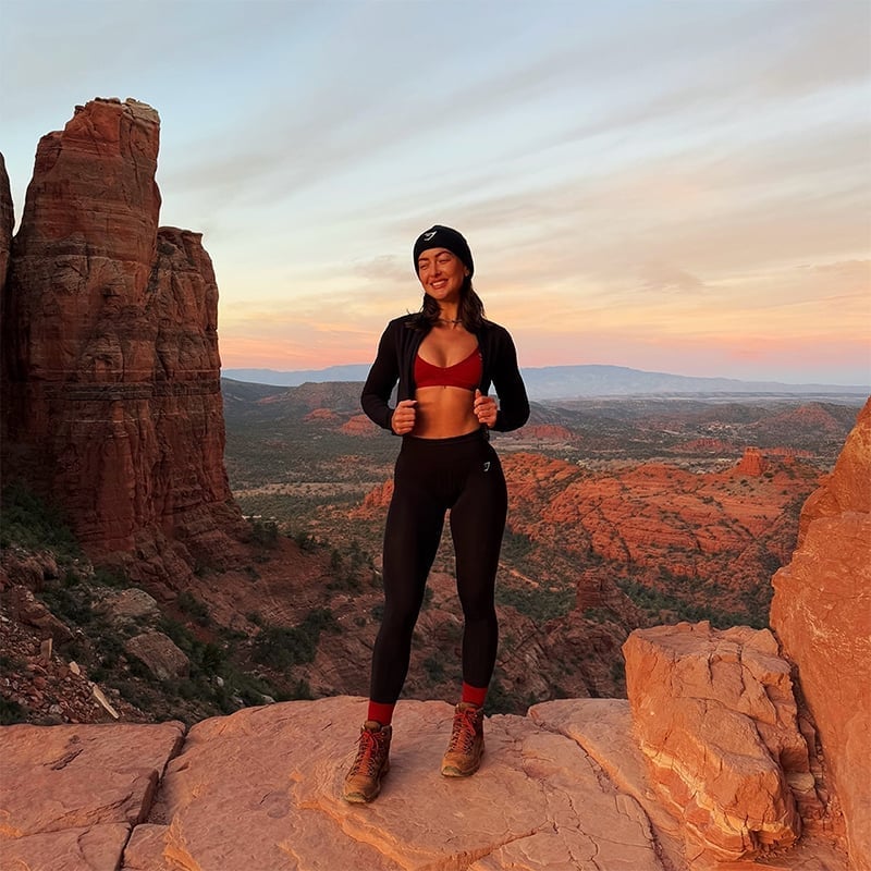 Zip-up Jacket, Sports Bra, and Leggings with Boots — Cute Hiking Outfit Inspo