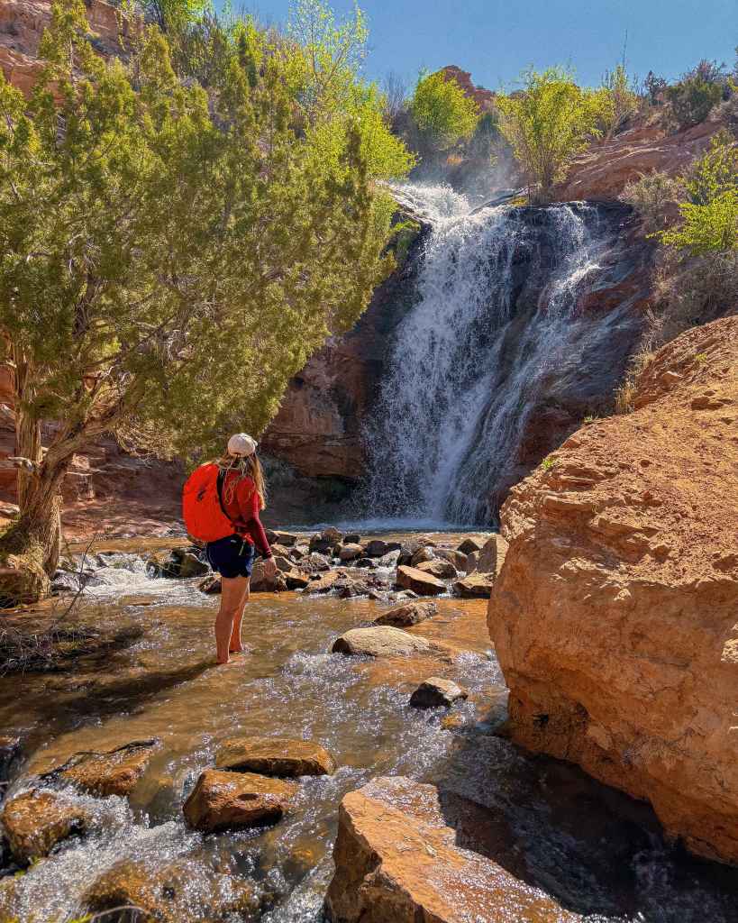 Red Long-Sleeve Shirt and Dark Shorts with Bright Backpack — Cute Hiking Outfit Inspo
