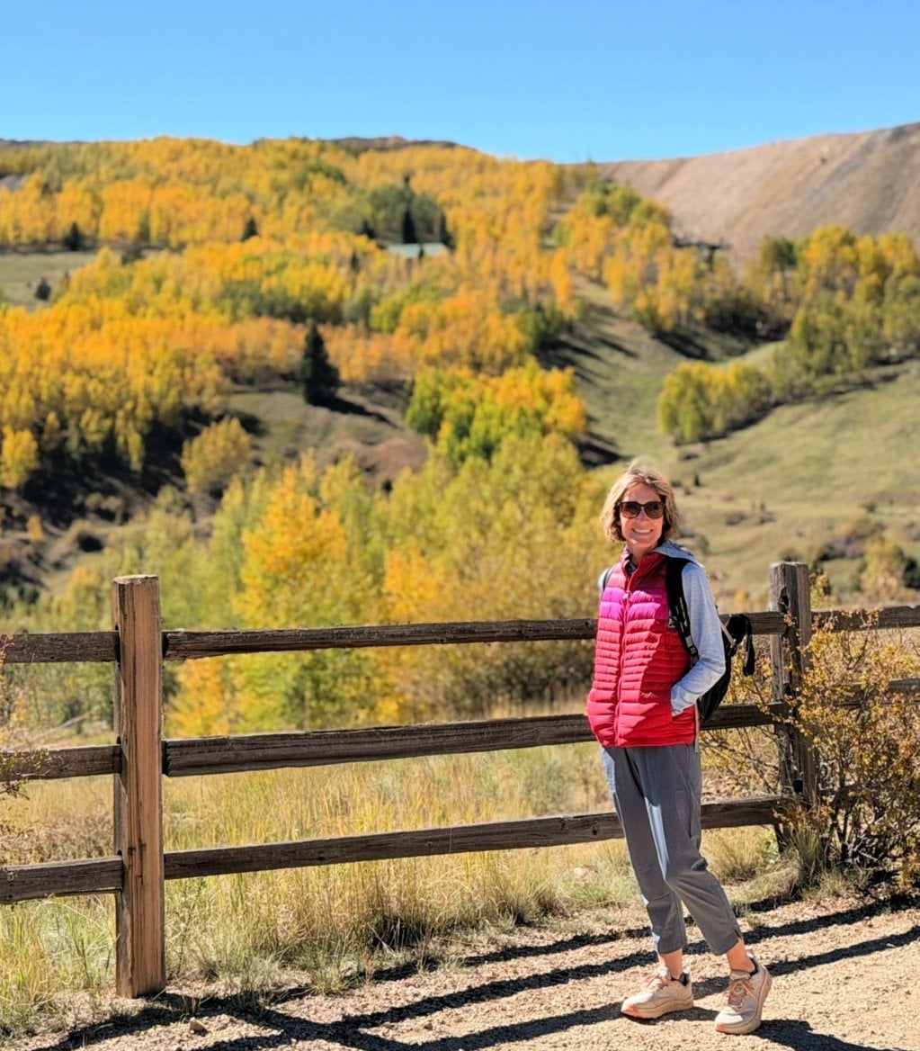 Puffer Vest Over Long-Sleeve Shirt and Grey Pants — Cute Hiking Outfit Inspo
