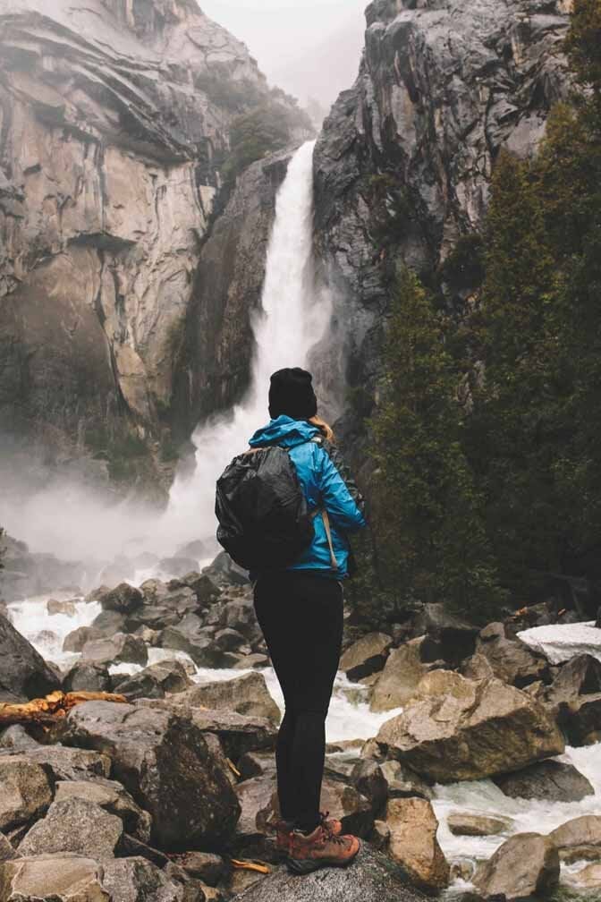 Bright Waterproof Jacket Over Slim Pants — Cute Hiking Outfit Inspo