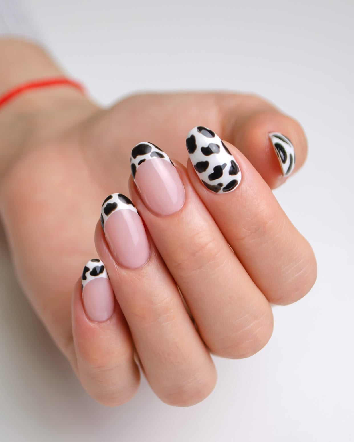 Nude Medium Oval with Black and White Cow Print Tips — Cute Medium Nails